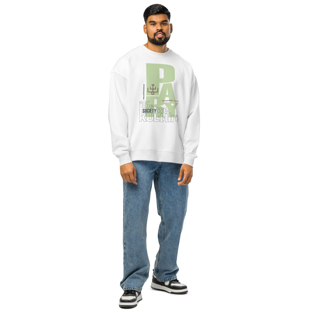 Full-body studio view of a male model wearing the white "Pray" organic cotton hoodie and blue jeans, highlighting the versatile, relaxed fit.